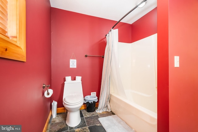 bathroom with shower / tub combo and toilet