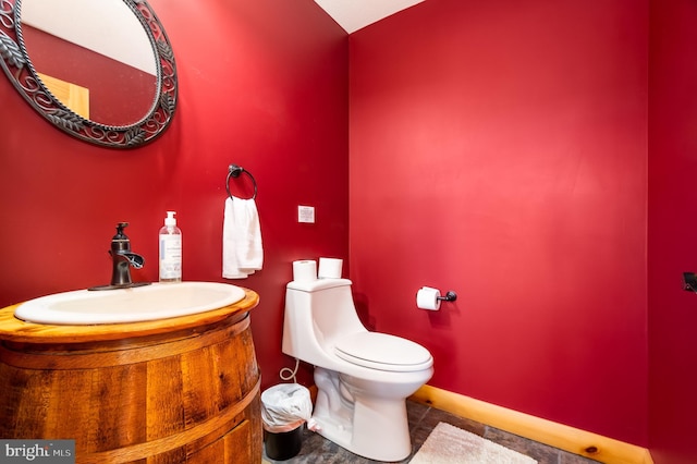 bathroom featuring vanity and toilet