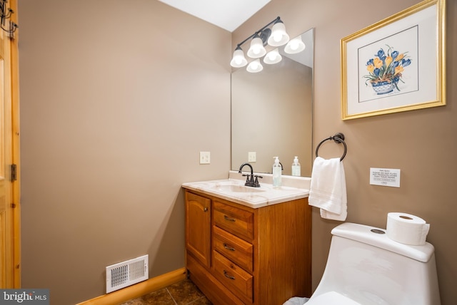 bathroom featuring vanity and toilet