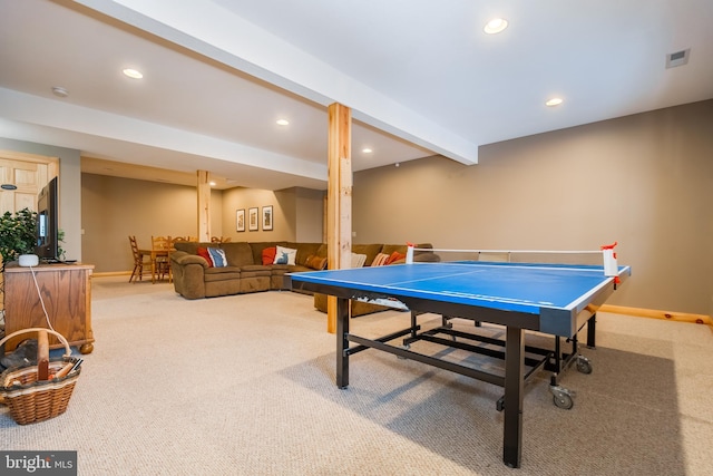 rec room featuring beam ceiling and carpet