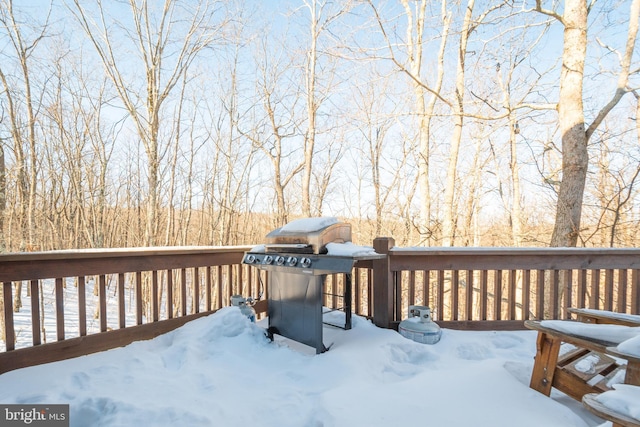 snow covered deck featuring grilling area