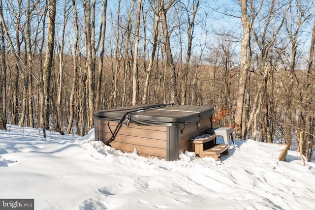 snowy yard with a hot tub