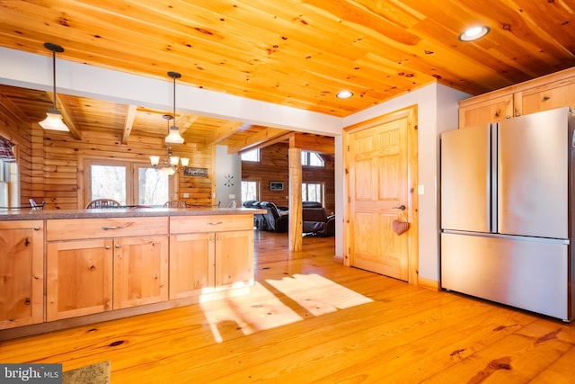 kitchen featuring stainless steel refrigerator, light hardwood / wood-style floors, decorative light fixtures, wooden ceiling, and light brown cabinets