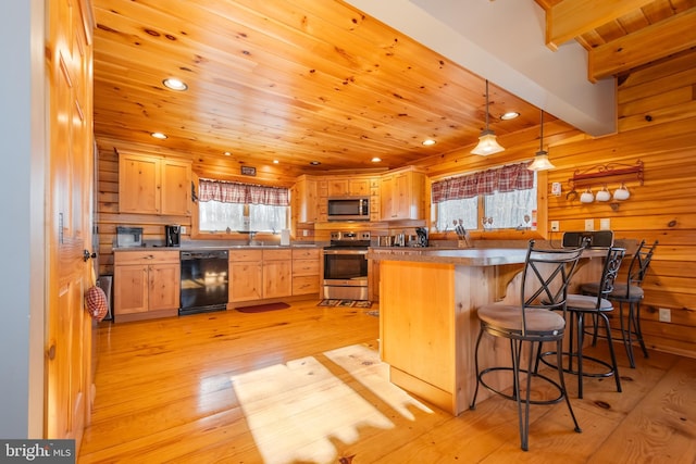 kitchen featuring decorative light fixtures, beamed ceiling, stainless steel appliances, light brown cabinets, and light wood-type flooring