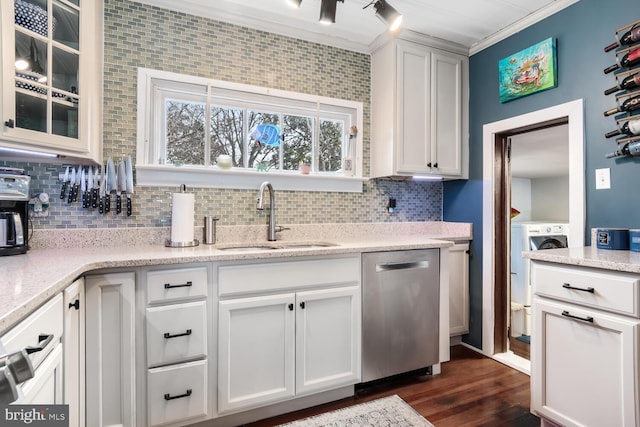 kitchen featuring white cabinetry, dishwasher, sink, and ornamental molding