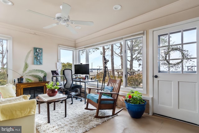 sunroom / solarium featuring ceiling fan