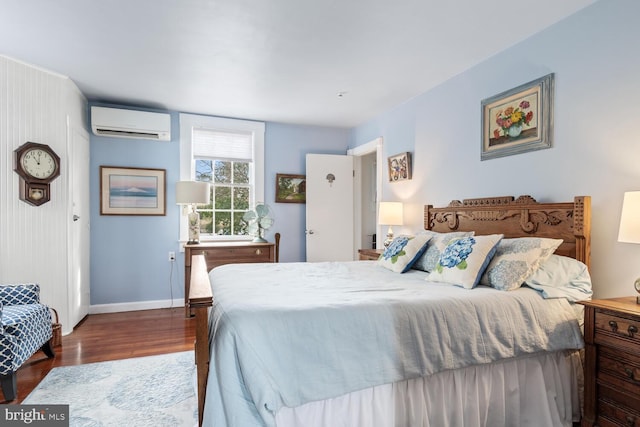 bedroom featuring dark hardwood / wood-style floors and a wall mounted AC