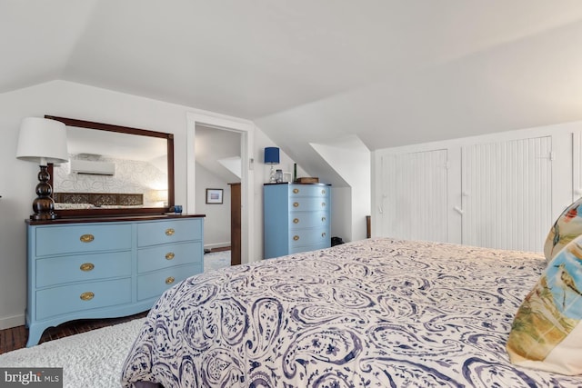 bedroom with dark hardwood / wood-style flooring and vaulted ceiling