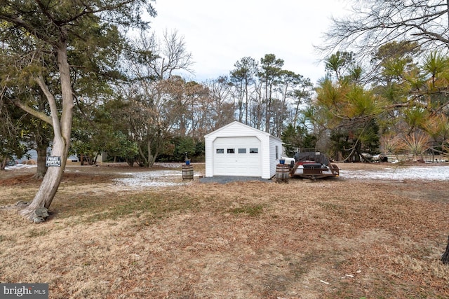 view of yard with a garage and an outbuilding