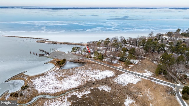 snowy aerial view with a water view