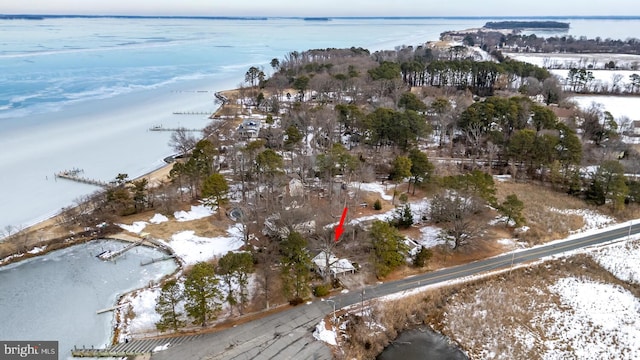 snowy aerial view with a water view