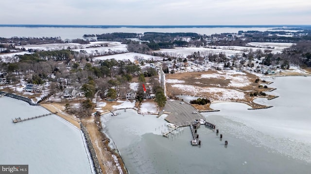 snowy aerial view with a water view