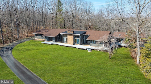 view of front of property with a deck and a front yard