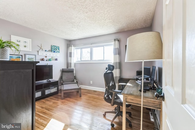 office area featuring hardwood / wood-style flooring and a textured ceiling