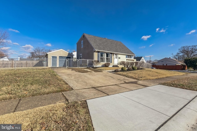 view of front of property featuring an outbuilding, a garage, and a front lawn