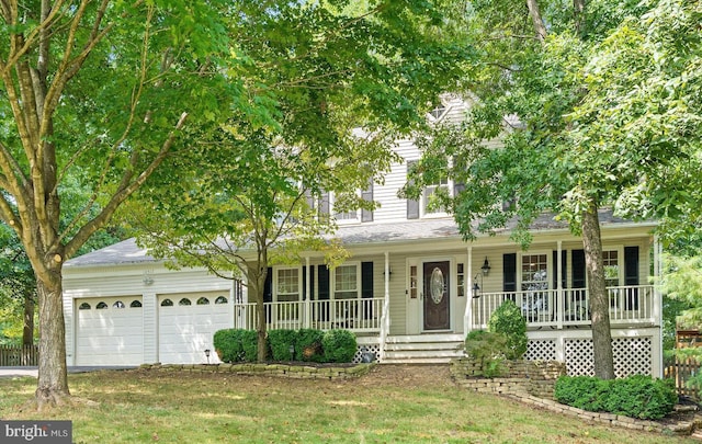 view of front facade with a garage, a front lawn, and a porch