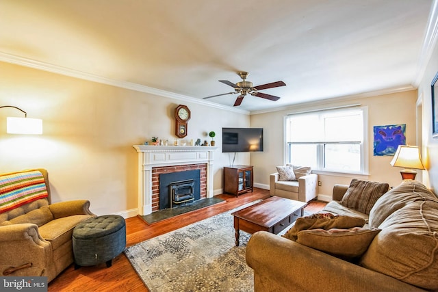 living room featuring hardwood / wood-style flooring, ceiling fan, and crown molding