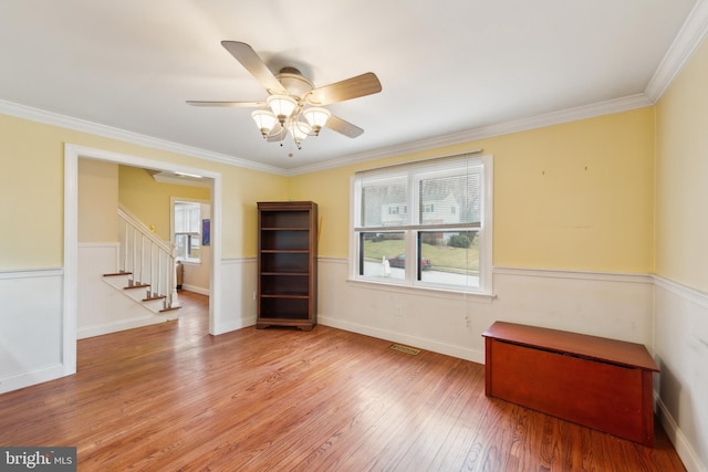 unfurnished room with ornamental molding, light hardwood / wood-style floors, and ceiling fan