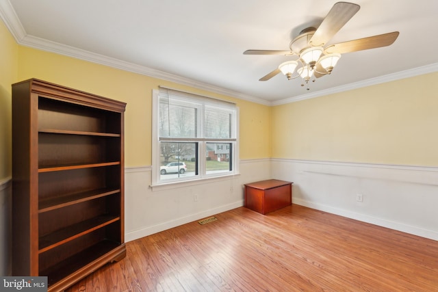 unfurnished room with crown molding, ceiling fan, and light wood-type flooring