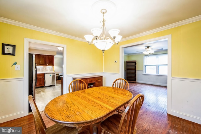 dining room featuring ornamental molding, ceiling fan with notable chandelier, and hardwood / wood-style floors