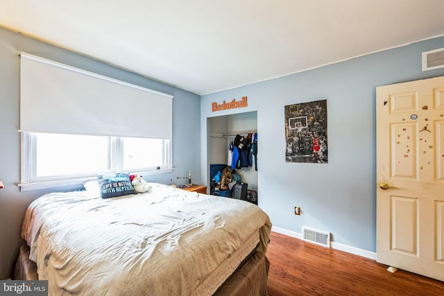 bedroom featuring hardwood / wood-style flooring and a closet