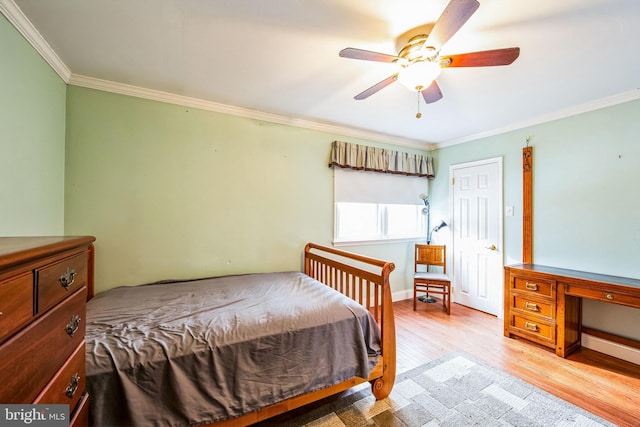 bedroom featuring crown molding, ceiling fan, and light wood-type flooring