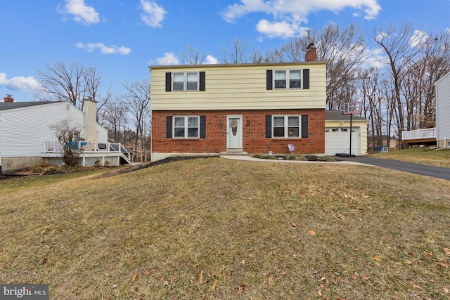 view of front of property with a garage and a front lawn