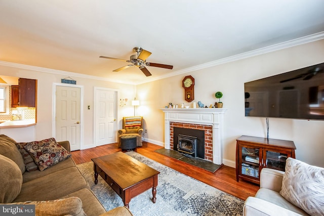 living room with crown molding, wood-type flooring, and ceiling fan