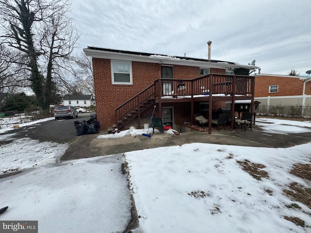 snow covered property featuring a deck