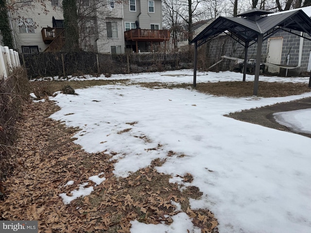 snowy yard featuring a gazebo