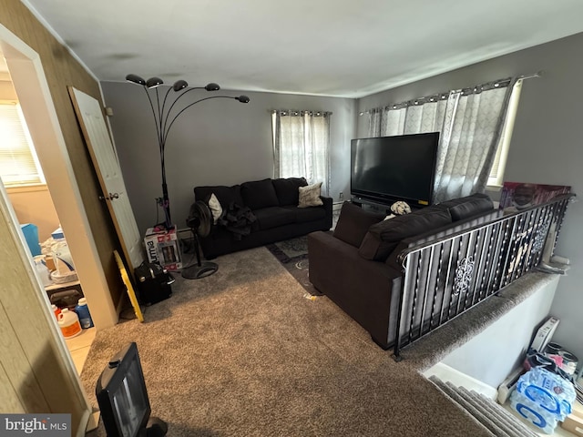 carpeted living room featuring wood walls