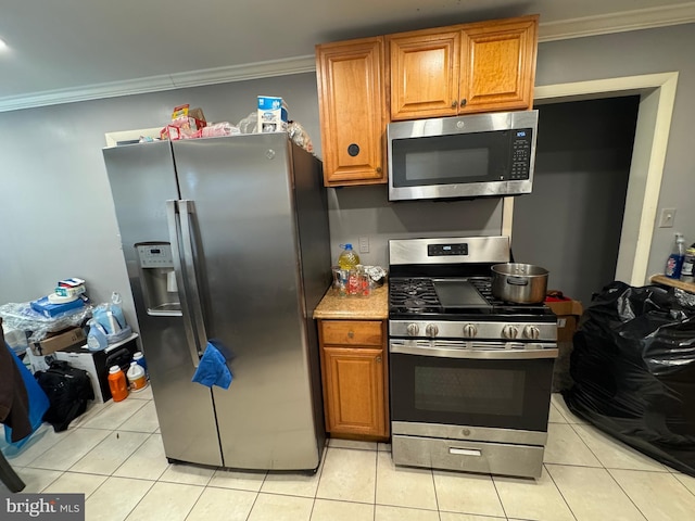 kitchen featuring ornamental molding, appliances with stainless steel finishes, and light tile patterned floors