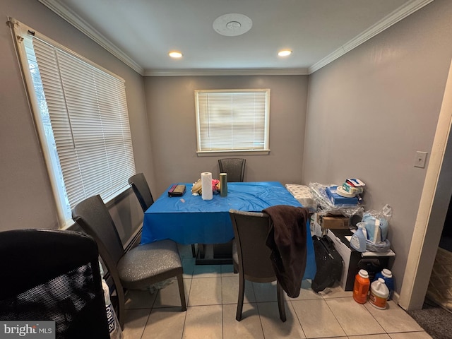 dining area featuring light tile patterned flooring and ornamental molding