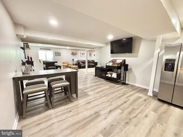 kitchen featuring light wood-type flooring and stainless steel fridge with ice dispenser