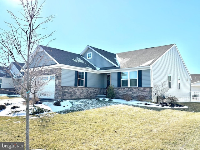 view of front of property with a garage and a front lawn