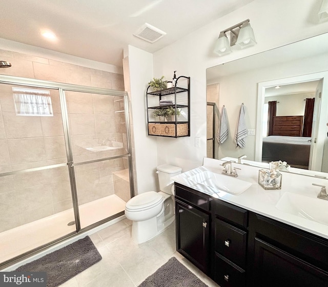 bathroom featuring tile patterned flooring, vanity, an enclosed shower, and toilet