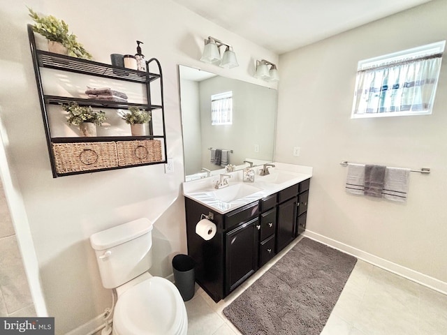 bathroom featuring plenty of natural light, toilet, and vanity