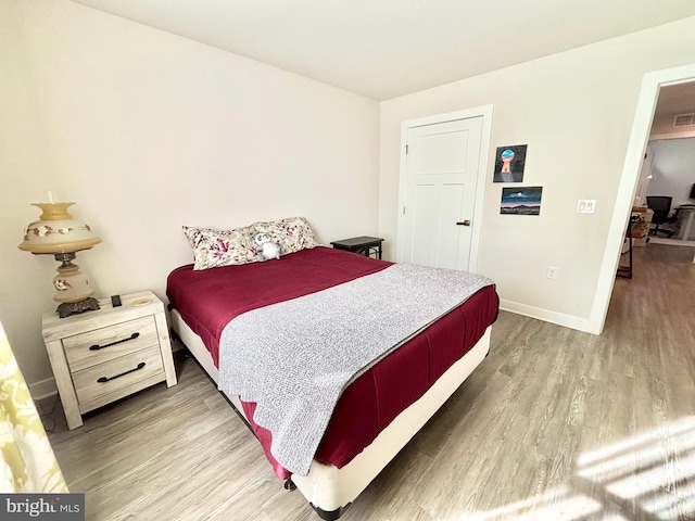 bedroom with hardwood / wood-style floors