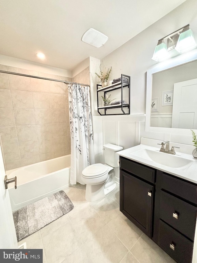 full bathroom with shower / tub combo with curtain, vanity, tile patterned floors, and toilet