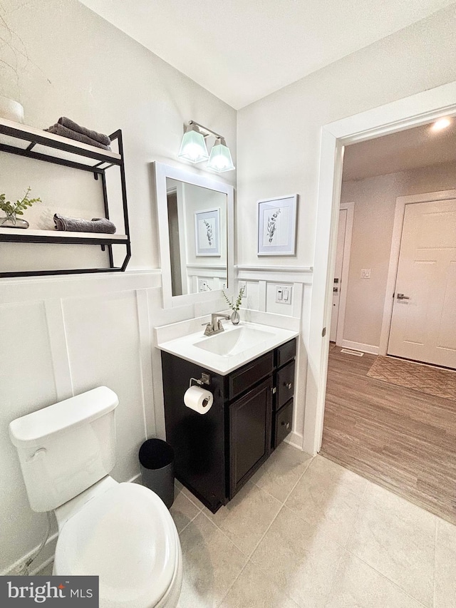 bathroom with vanity, toilet, and wood-type flooring