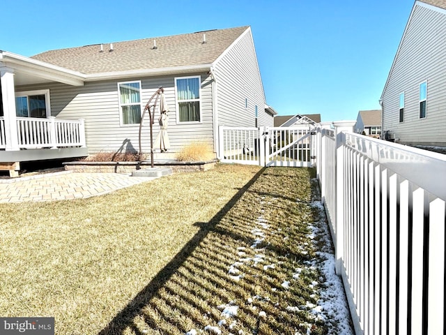 rear view of property with a lawn