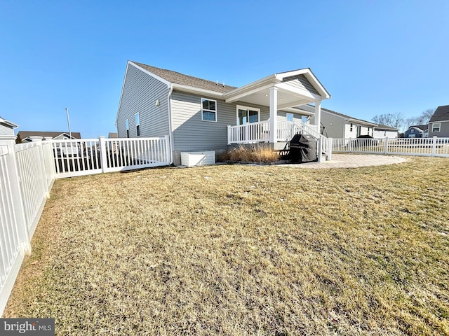 exterior space featuring a patio area and a lawn