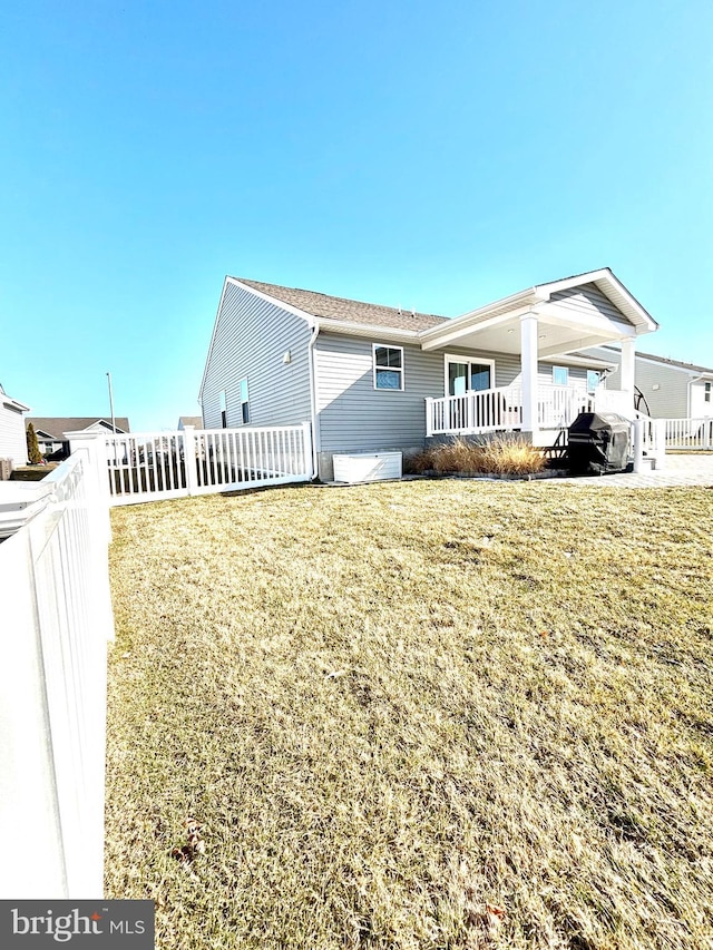 back of house with a lawn