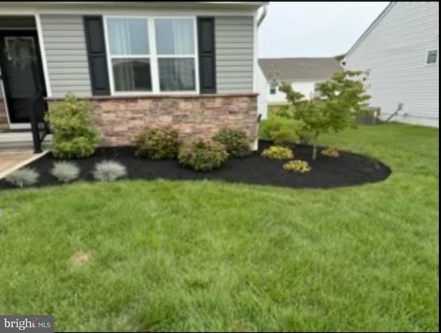 view of side of home with a lawn