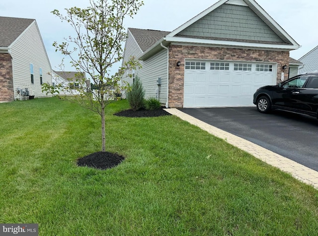 view of side of property featuring a garage and a lawn