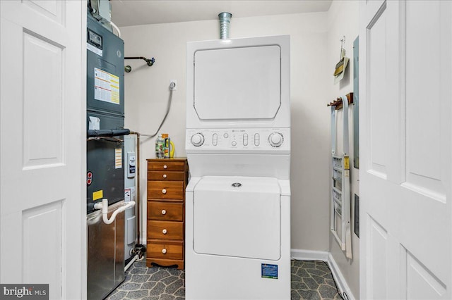 laundry area with stacked washing maching and dryer