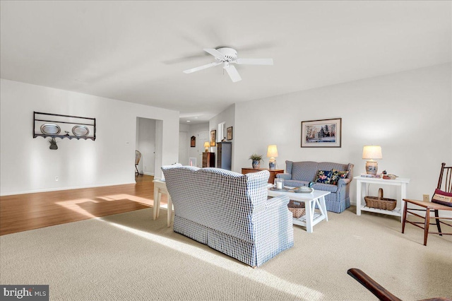 living room featuring carpet floors and ceiling fan