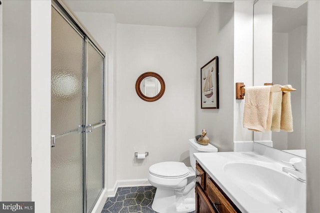 bathroom with vanity, toilet, and an enclosed shower