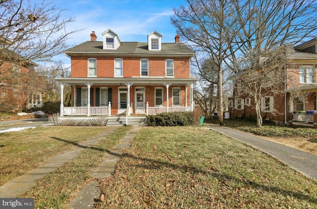 view of front of house featuring covered porch and a front lawn