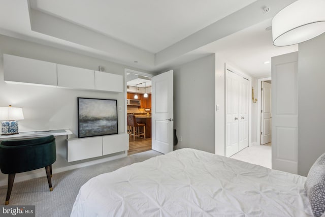 bedroom featuring light carpet